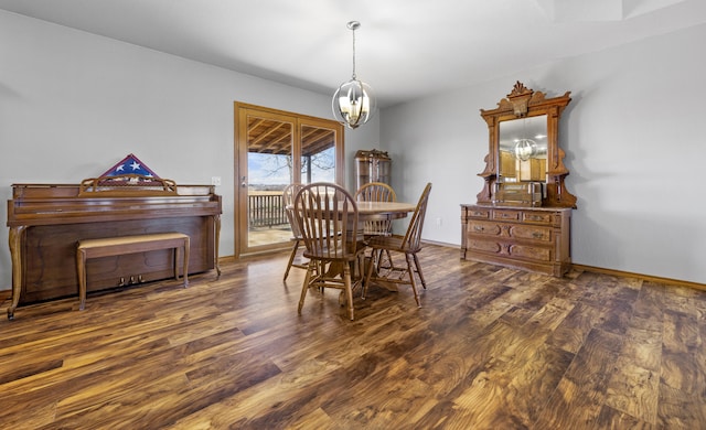 dining room featuring dark hardwood / wood-style floors and an inviting chandelier