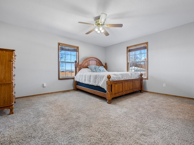 bedroom featuring ceiling fan, carpet floors, and multiple windows