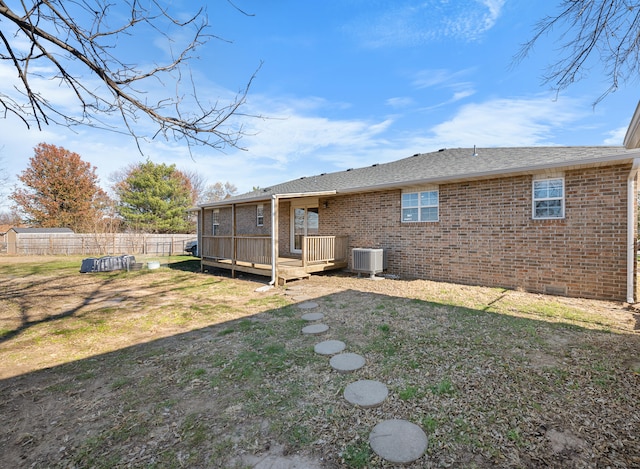 back of property featuring a yard, central air condition unit, and a wooden deck