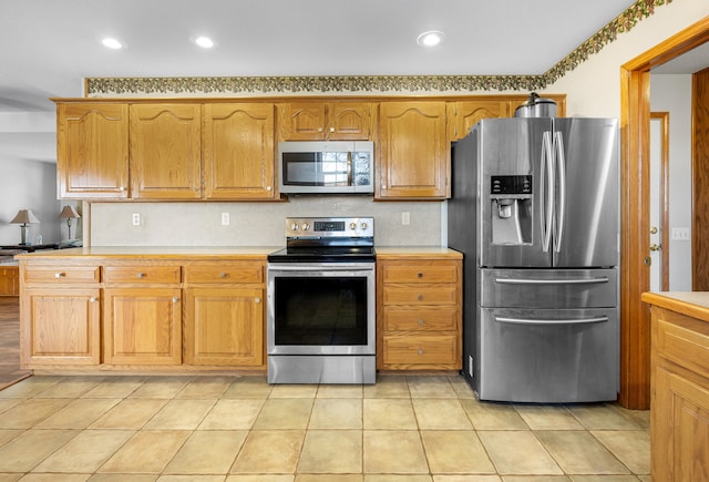 kitchen featuring light tile patterned flooring and appliances with stainless steel finishes