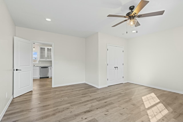 spare room featuring light hardwood / wood-style floors and ceiling fan