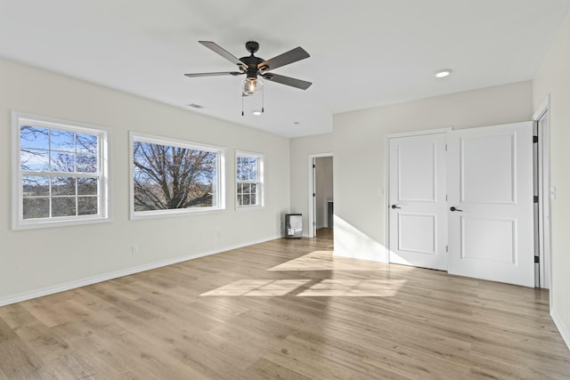 unfurnished bedroom with light hardwood / wood-style flooring and ceiling fan