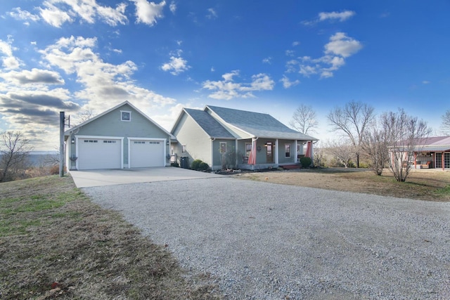 view of front of home featuring covered porch and a garage