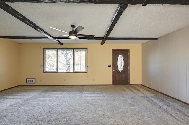 interior space with a wealth of natural light, beamed ceiling, and a textured ceiling