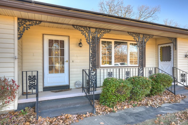 view of exterior entry featuring covered porch