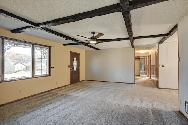 unfurnished living room with beamed ceiling and a textured ceiling