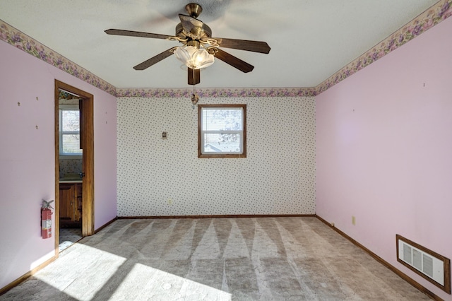 empty room with plenty of natural light and ceiling fan