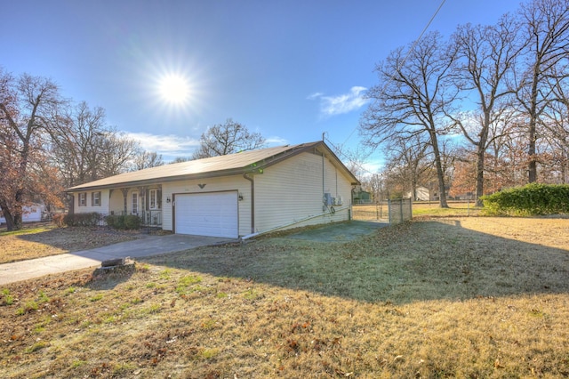 view of home's exterior with a yard and a garage