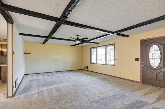 carpeted foyer featuring ceiling fan, coffered ceiling, beamed ceiling, and a textured ceiling