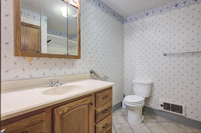 bathroom featuring tile patterned floors, vanity, a textured ceiling, and toilet