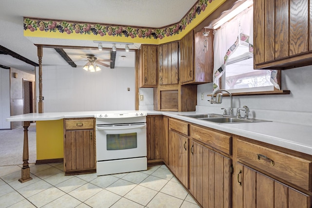 kitchen with ceiling fan, sink, a textured ceiling, light tile patterned floors, and white stove