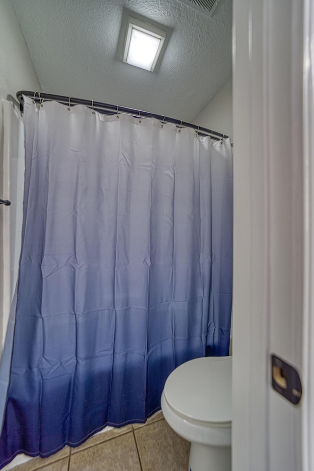 29 Fall Creek Dr Unit 2, Branson, MO 65616 - full bath with a textured ceiling, tile patterned flooring, and curtained shower