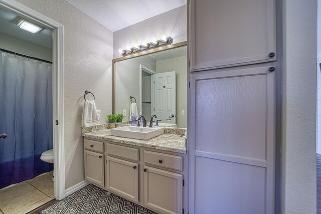 29 Fall Creek Dr Unit 2, Branson, MO 65616 - bathroom featuring a textured wall, vanity, tile patterned floors, and a shower with shower curtain