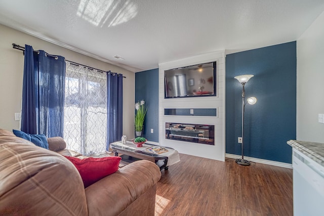29 Fall Creek Dr Unit 2, Branson, MO 65616 - living room with wood finished floors, a textured ceiling, and a fireplace