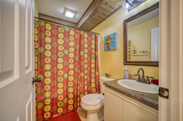 bathroom featuring tile patterned flooring, a textured ceiling, vanity, and toilet