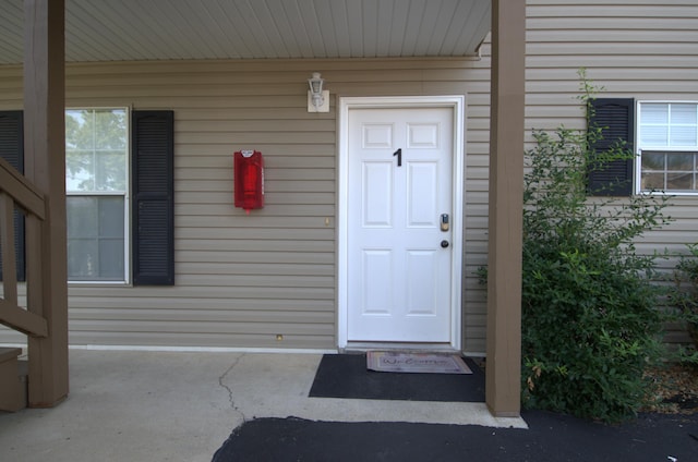 view of exterior entry featuring a porch