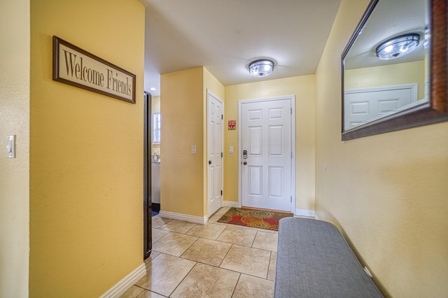 doorway with light tile patterned floors