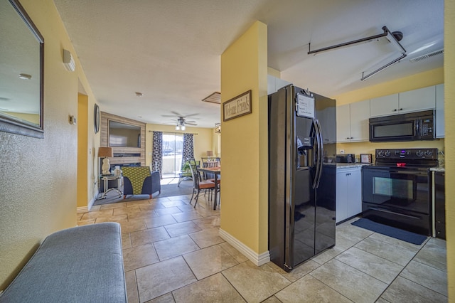 kitchen with ceiling fan, white cabinets, black appliances, and light tile patterned floors