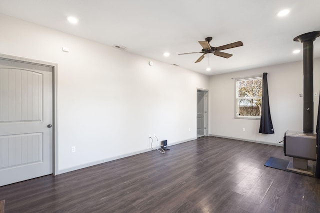 unfurnished living room featuring ceiling fan and dark wood-type flooring