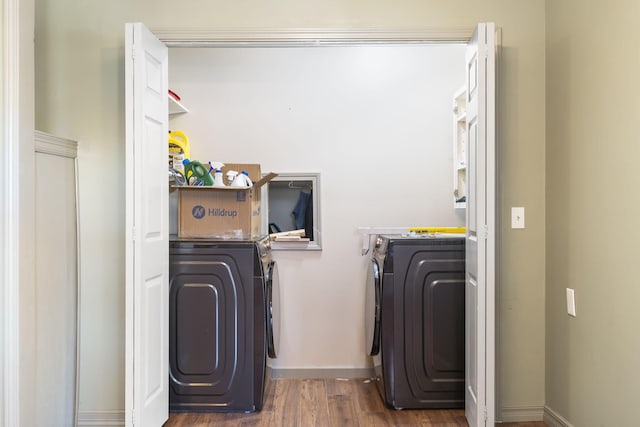 washroom with washer and dryer and dark wood-type flooring