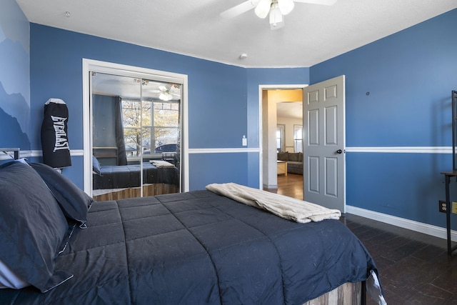 bedroom featuring ceiling fan, a closet, and dark wood-type flooring