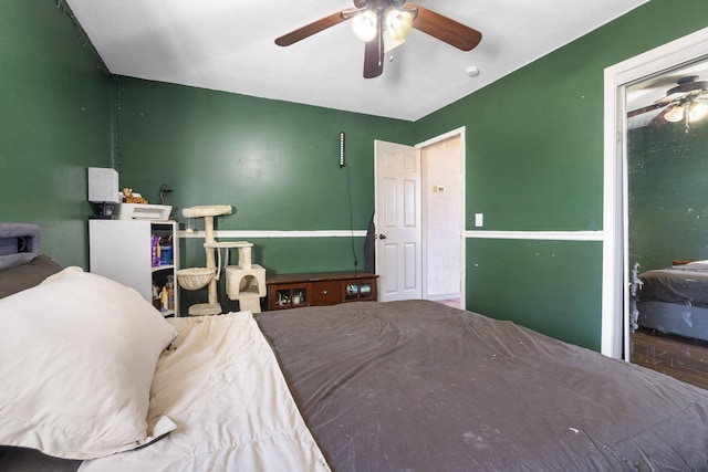 bedroom with hardwood / wood-style floors and ceiling fan