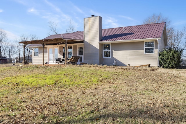 rear view of house featuring a yard