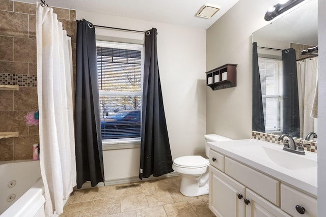 full bathroom featuring shower / bath combo, vanity, toilet, and a wealth of natural light