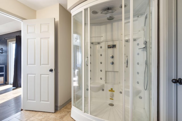 bathroom with tile patterned flooring and walk in shower