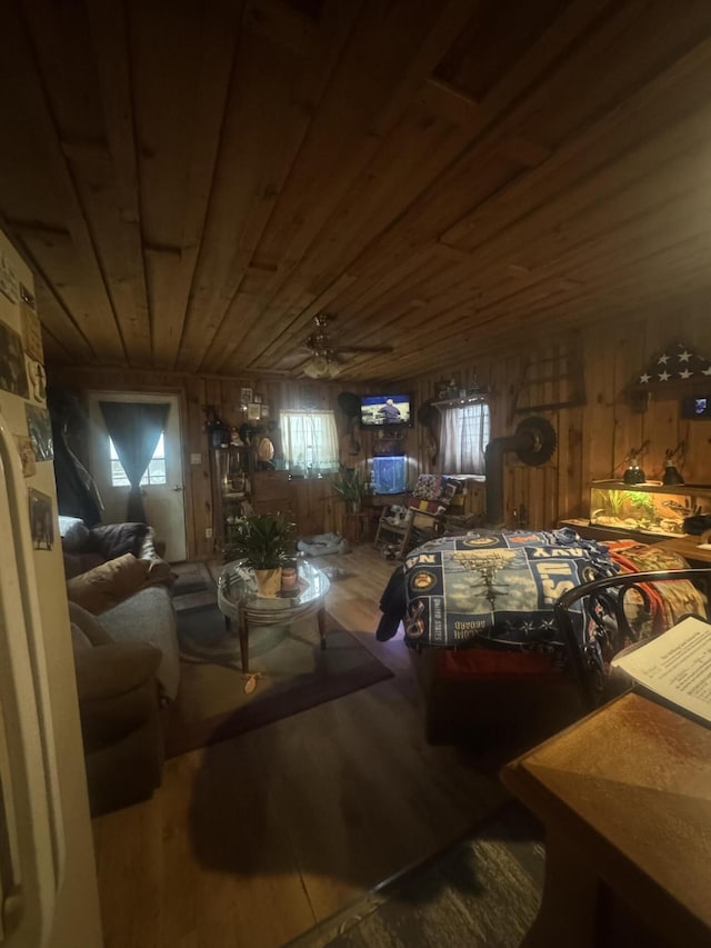 bedroom with wood-type flooring, wooden walls, and wood ceiling