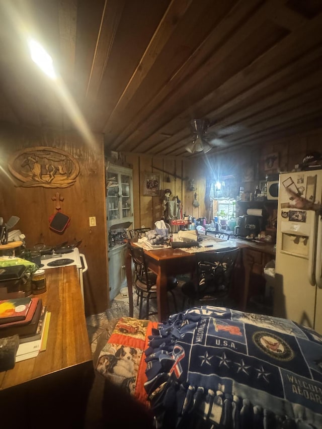 interior space with wood walls and white fridge