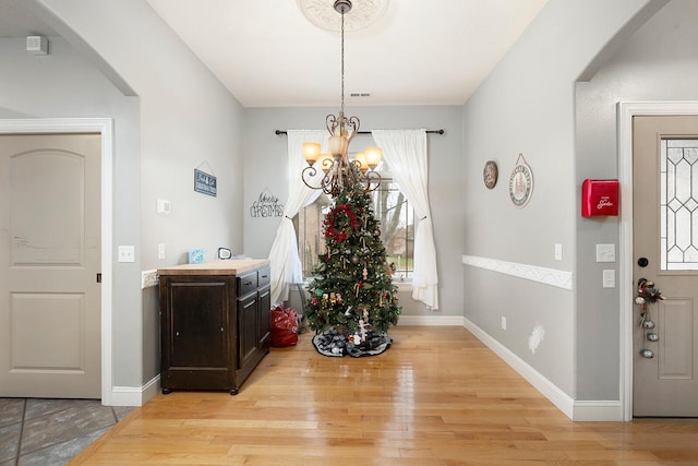 entryway with a chandelier and light hardwood / wood-style floors