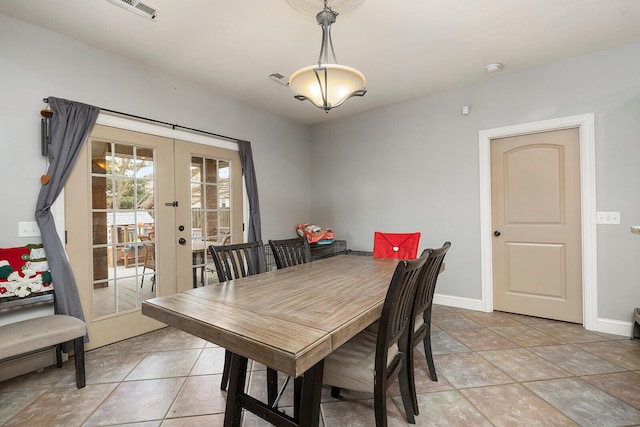 dining area with french doors and light tile patterned flooring