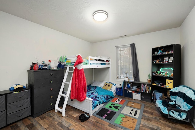 bedroom with dark wood-type flooring