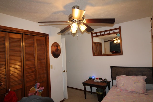 carpeted bedroom featuring a textured ceiling, a closet, and ceiling fan