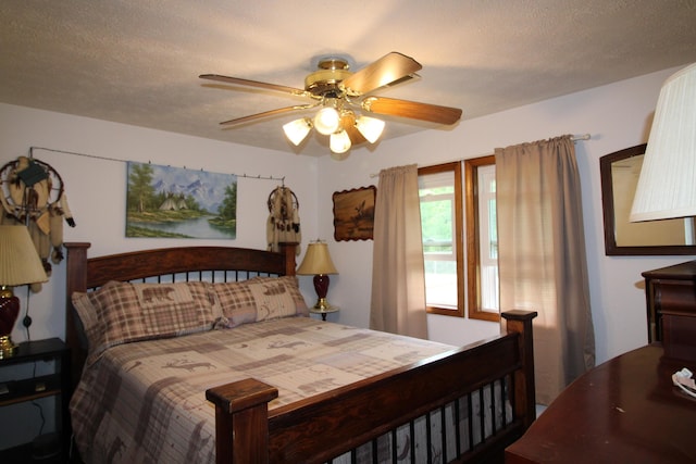 bedroom with a textured ceiling and ceiling fan