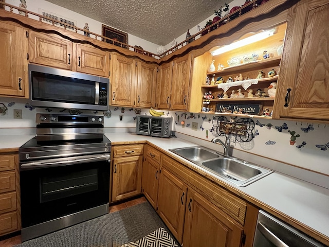 180 Wilshire Dr Unit 88, Hollister, MO 65672 - kitchen featuring appliances with stainless steel finishes, light countertops, a textured ceiling, open shelves, and brown cabinetry