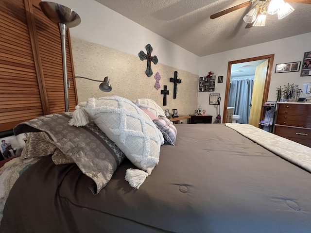 180 Wilshire Dr Unit 88, Hollister, MO 65672 - bedroom with ceiling fan, a textured ceiling, and ensuite bathroom