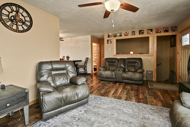 living room featuring a textured ceiling, dark hardwood / wood-style flooring, and ceiling fan