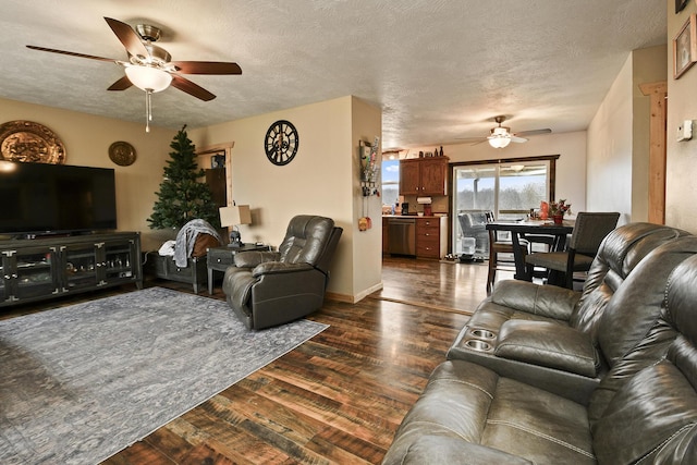 living room with ceiling fan, dark hardwood / wood-style flooring, and a textured ceiling