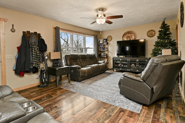 living room featuring a textured ceiling, ceiling fan, and dark hardwood / wood-style floors