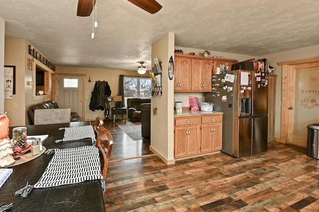 kitchen with stainless steel fridge with ice dispenser, a textured ceiling, ceiling fan, and dark wood-type flooring