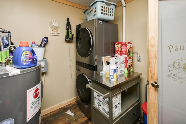 washroom featuring water heater, stacked washer and dryer, and dark wood-type flooring