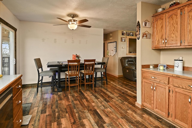 dining space with ceiling fan, dark hardwood / wood-style flooring, and a textured ceiling