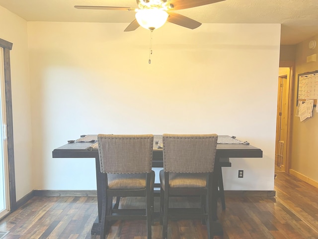 dining area featuring ceiling fan and dark hardwood / wood-style flooring