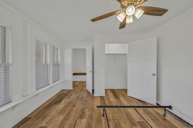 213 Mill St, Anderson, MO 64831 - unfurnished bedroom featuring wood finished floors, a closet, a ceiling fan, and baseboards