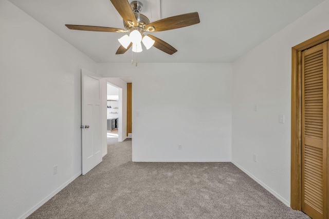213 Mill St, Anderson, MO 64831 - unfurnished bedroom featuring carpet, a closet, baseboards, and a ceiling fan