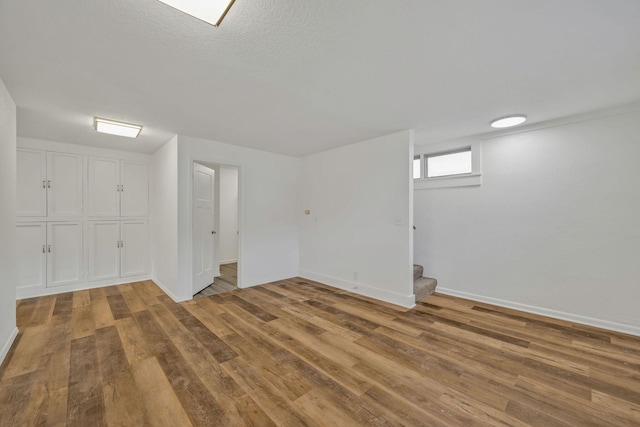 213 Mill St, Anderson, MO 64831 - below grade area featuring wood finished floors, stairway, and baseboards