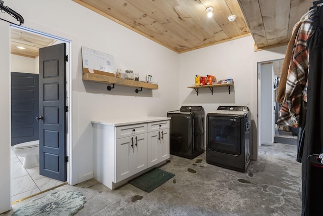 laundry room with wooden ceiling and washing machine and clothes dryer