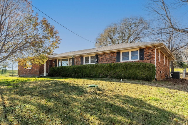 ranch-style home with central AC and a front lawn